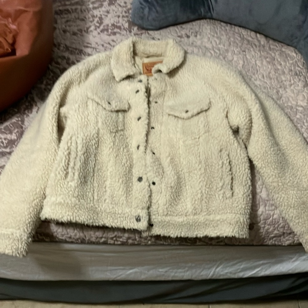 Levi Strauss size medium cream colored button up coat.